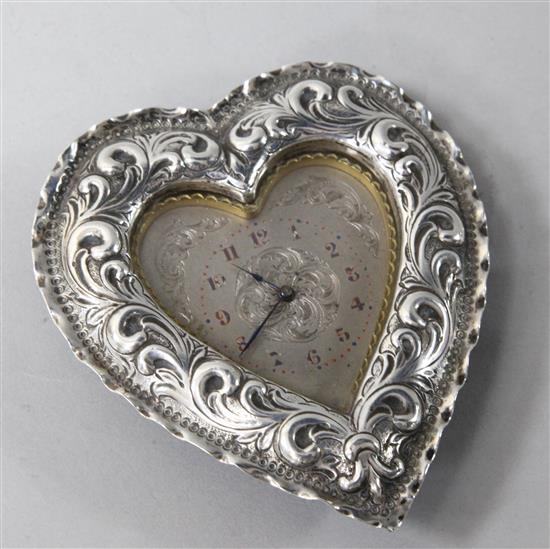 A late Victorian repousse silver mounted heart shaped timepiece, by Charles Mappin, London, 1888, 10.5cm.